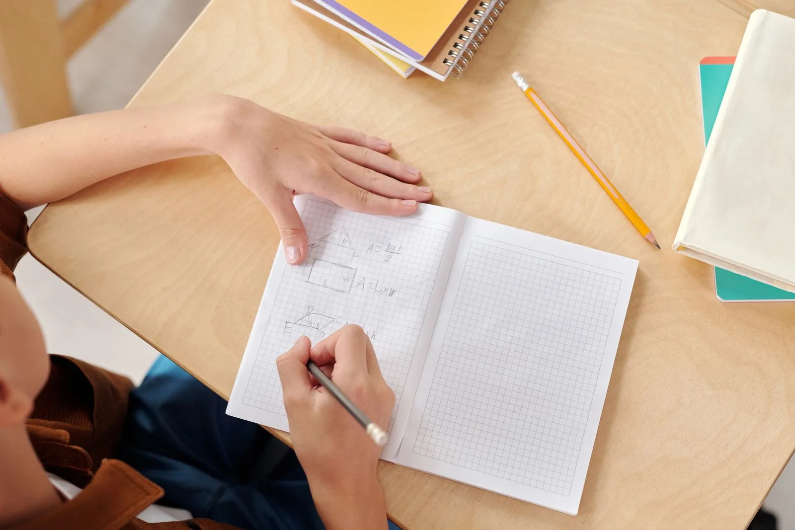 A learner making a visible attempt in a maths notebook